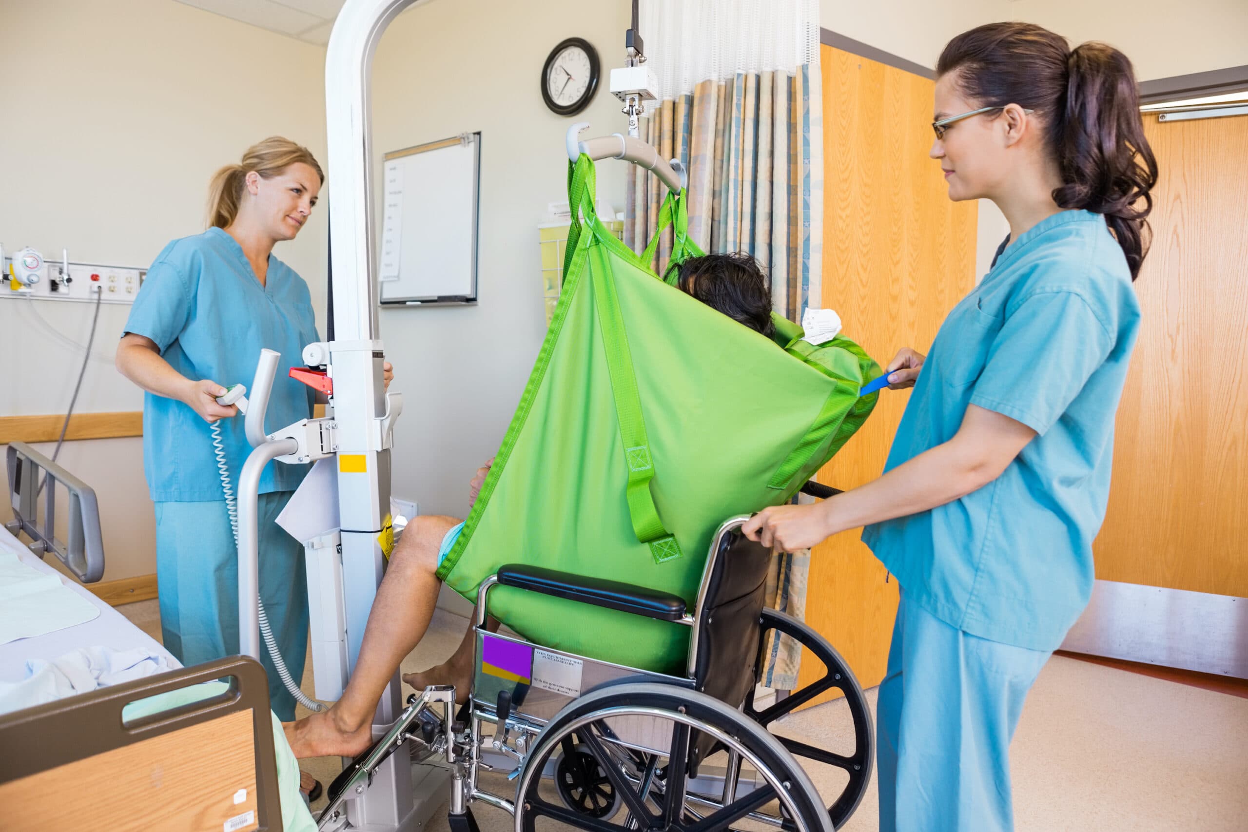 Home health aide assisting with a safe wheelchair transfer in New York City